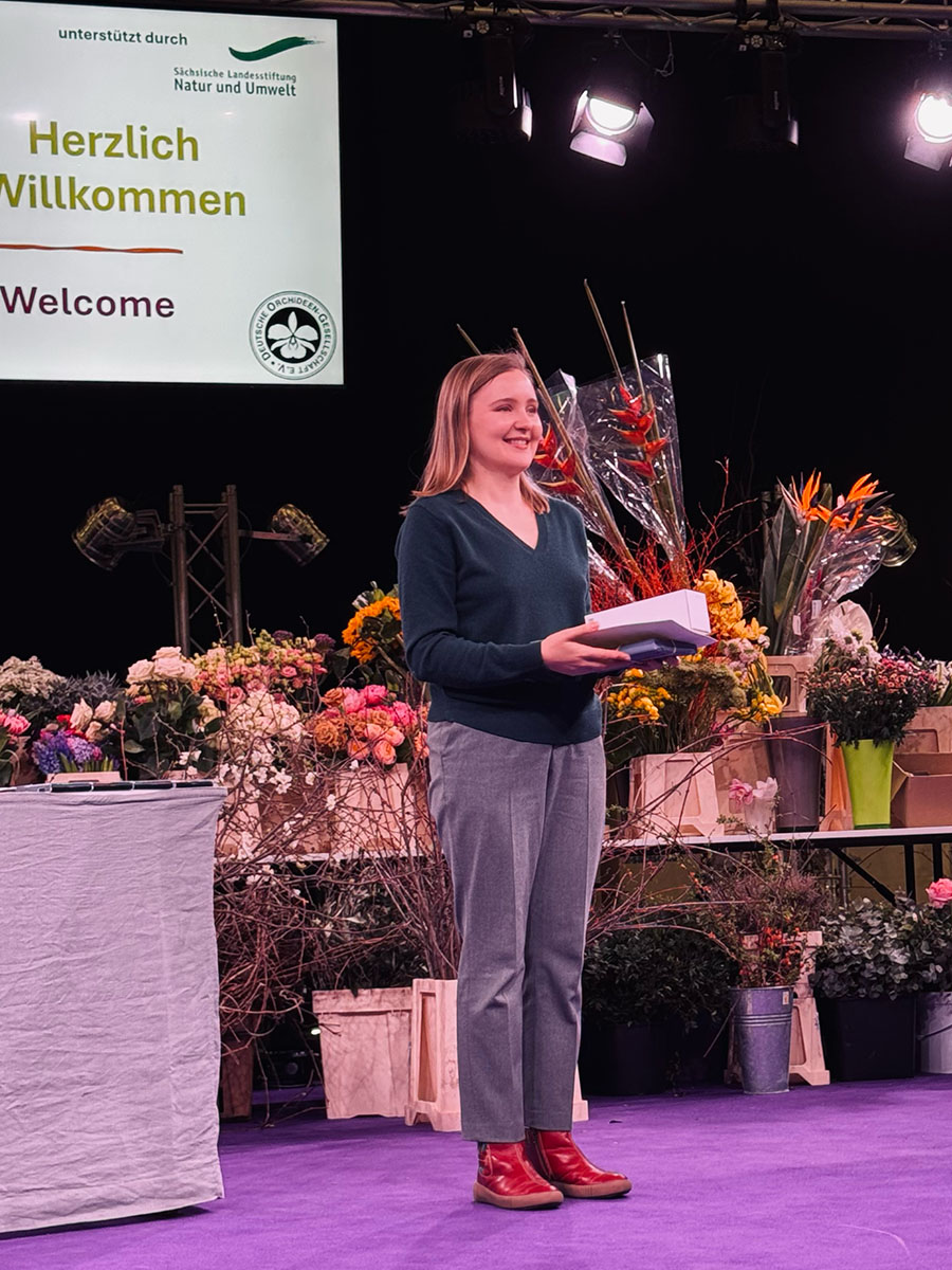 Daria receiving the Certificate of Merit at the 24th World Orchid Conference 2026, Dresden
